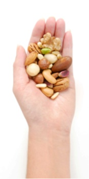 Handful of mixed nuts in a palm